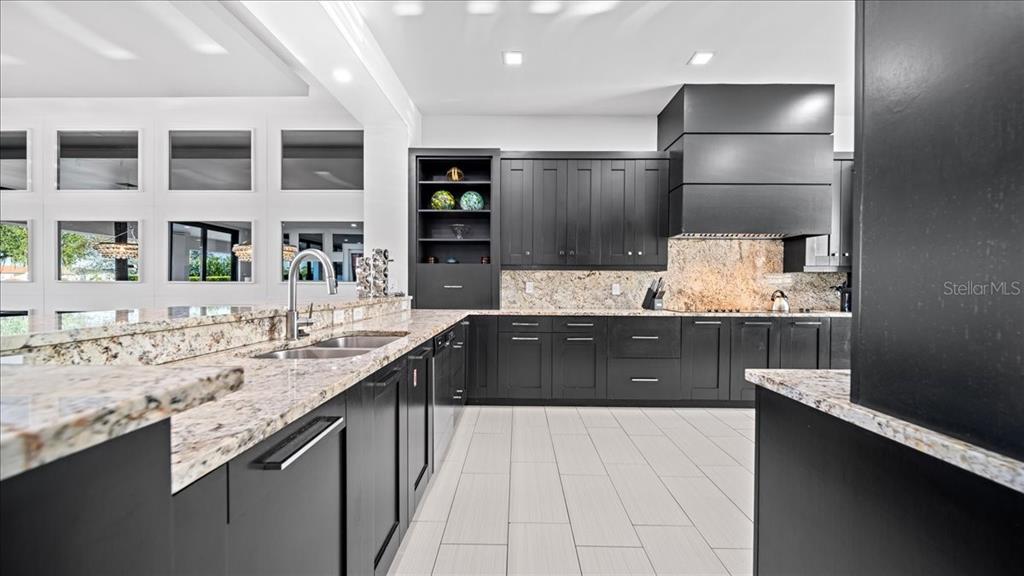 331 Muirfield Loop Reunion, FL 34747 - Photo 79 of 100 a large kitchen with granite countertop a sink and a refrigerator