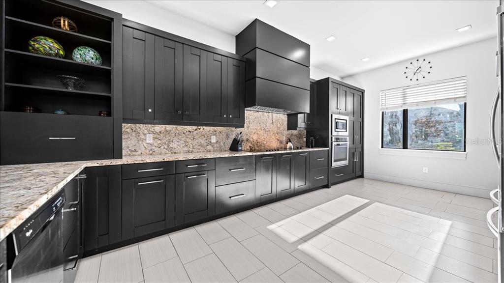 331 Muirfield Loop Reunion, FL 34747 - Photo 80 of 100 a kitchen with stainless steel appliances granite countertop a sink stove and cabinets