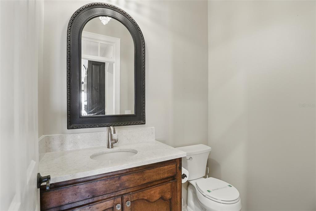 106 Victoria Street Merritt Island, FL 32952 - Photo 15 of 51 a bathroom with a sink a toilet and mirror