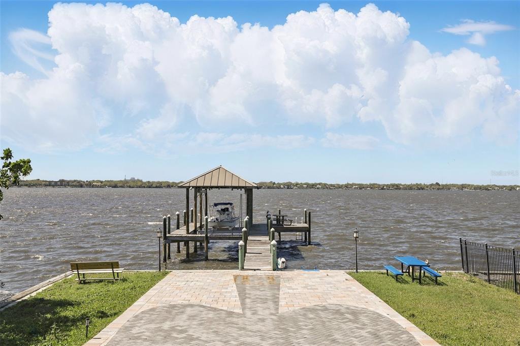 106 Victoria Street Merritt Island, FL 32952 - Photo 50 of 51 a view of a lake with a table and chairs next to an ocean