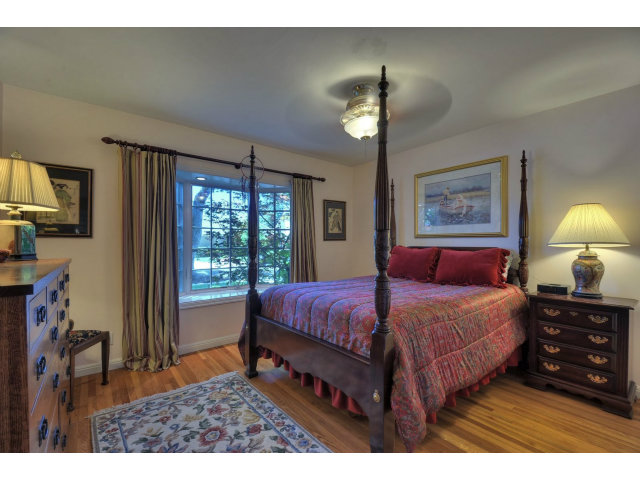 350 Velarde Street Mountain View, CA 94041 - Photo 13 of 24 a bedroom with a bed a chandelier and a flat tv screen on dresser