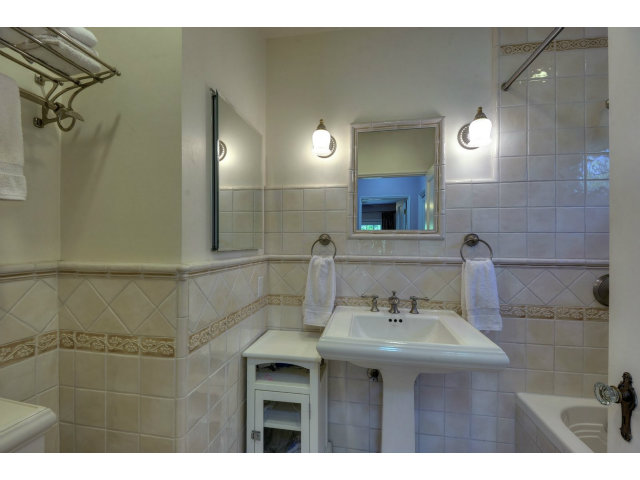 350 Velarde Street Mountain View, CA 94041 - Photo 14 of 24 a bathroom with a sink mirror and a shower