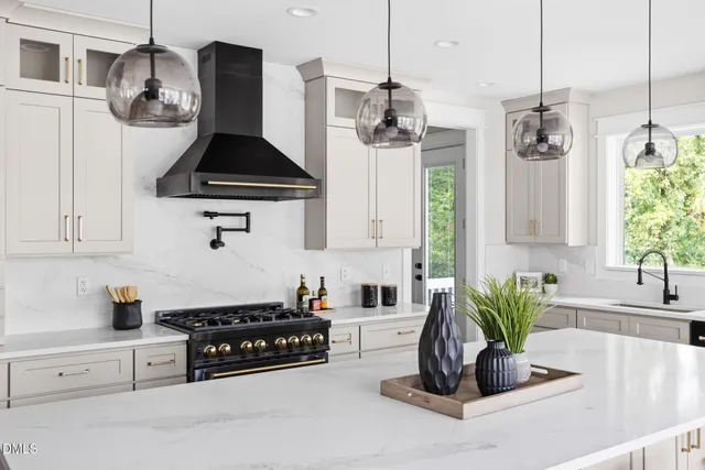 a kitchen with stainless steel appliances a dining table chairs and wooden floor