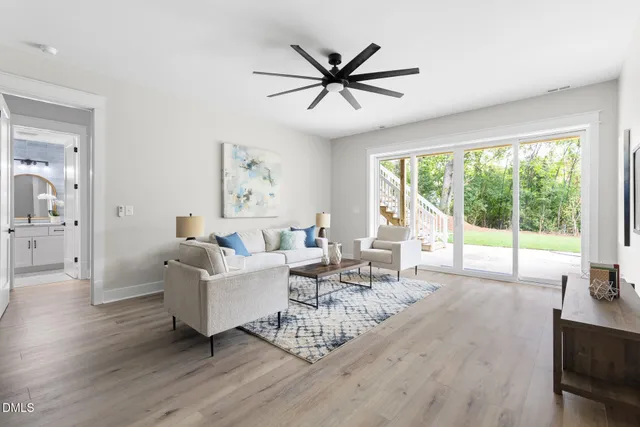 a kitchen with stainless steel appliances granite countertop a refrigerator a sink dishwasher a stove and white cabinets with wooden floor