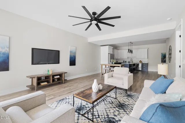 a living room with furniture and a large window with wooden floor