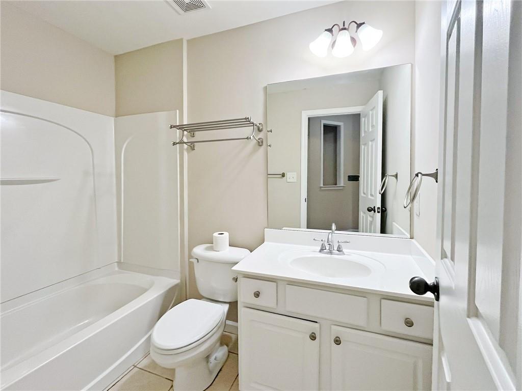 525 Grove Field Court Northwest Suwanee, GA 30024 - Photo 12 of 57 a bathroom with a sink toilet and shower