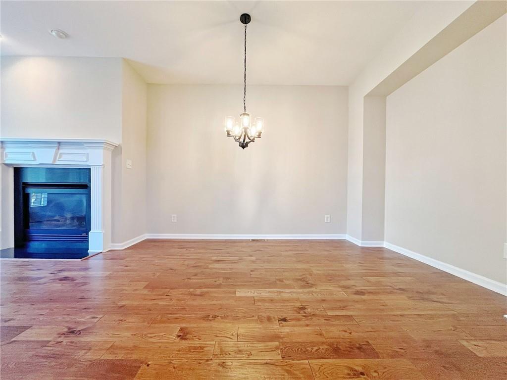 525 Grove Field Court Northwest Suwanee, GA 30024 - Photo 17 of 57 a view of a room with wooden floor and ceiling fan