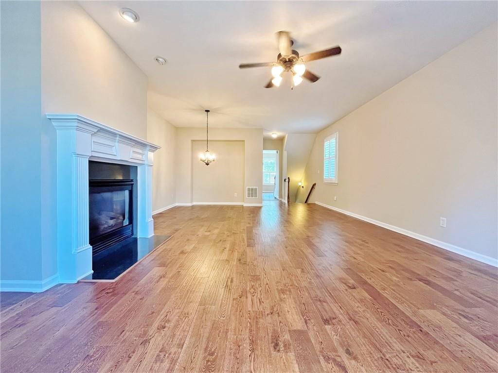 525 Grove Field Court Northwest Suwanee, GA 30024 - Photo 18 of 57 a view of an empty room with wooden floor and a fireplace