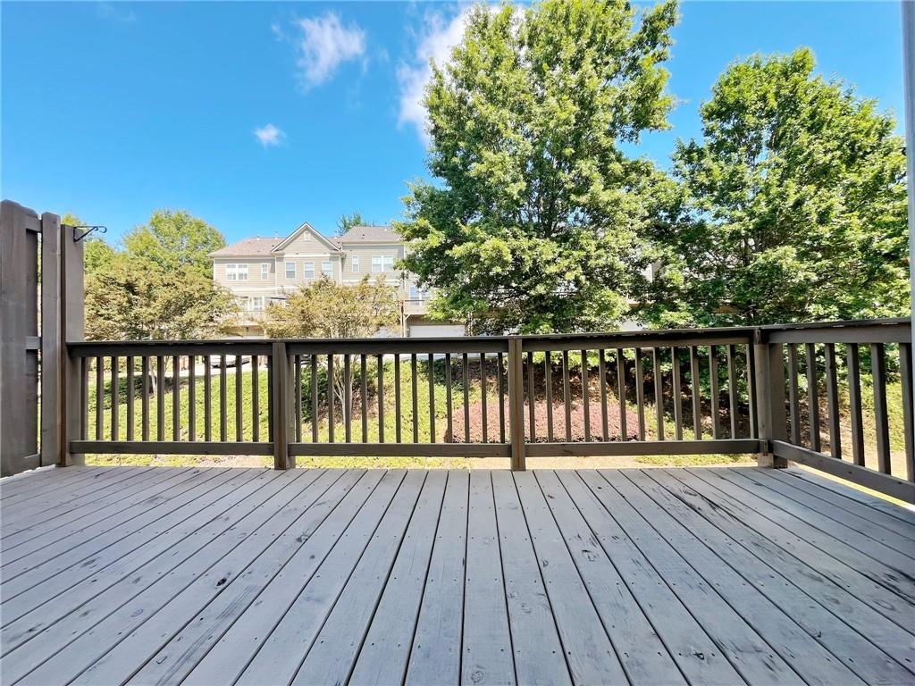 525 Grove Field Court Northwest Suwanee, GA 30024 - Photo 19 of 57 a view of wooden balcony with a lake