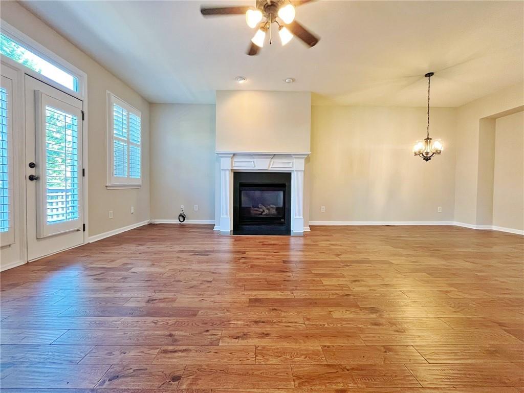 525 Grove Field Court Northwest Suwanee, GA 30024 - Photo 22 of 57 a view of an empty room with a fireplace and a window