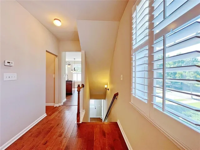 a kitchen with stainless steel appliances granite countertop wooden floors and granite counter tops