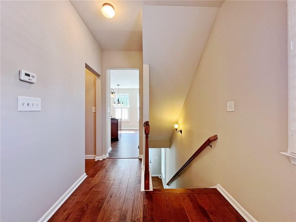 525 Grove Field Court Northwest Suwanee, GA 30024 - Photo 24 of 57 a view of a hallway with wooden floor and staircase
