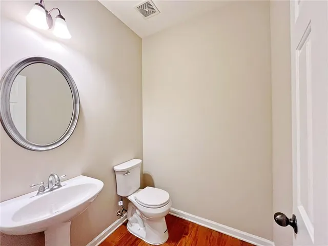 a kitchen with stainless steel appliances granite countertop a stove a refrigerator and wooden floors