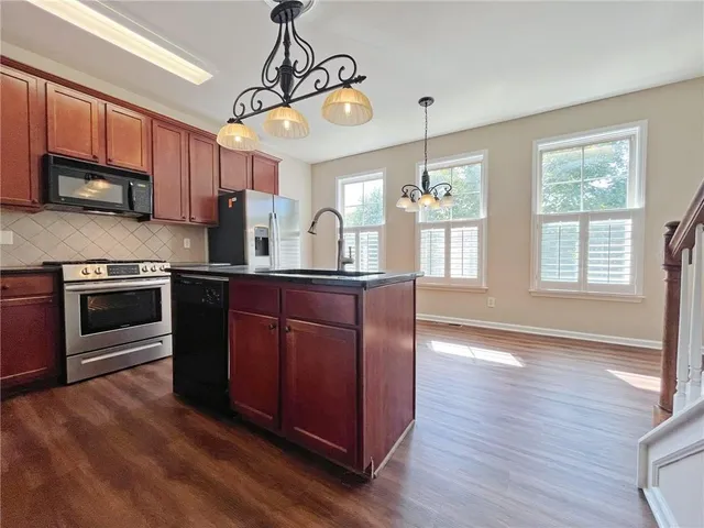 a kitchen with wooden floors and a sink