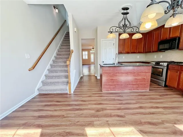 a view of a big room with chandelier fan and windows