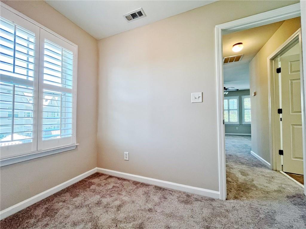 525 Grove Field Court Northwest Suwanee, GA 30024 - Photo 32 of 57 a view of an empty room with window and bathroom