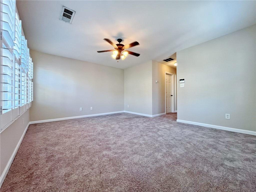 525 Grove Field Court Northwest Suwanee, GA 30024 - Photo 35 of 57 a view of a big room with chandelier fan and windows