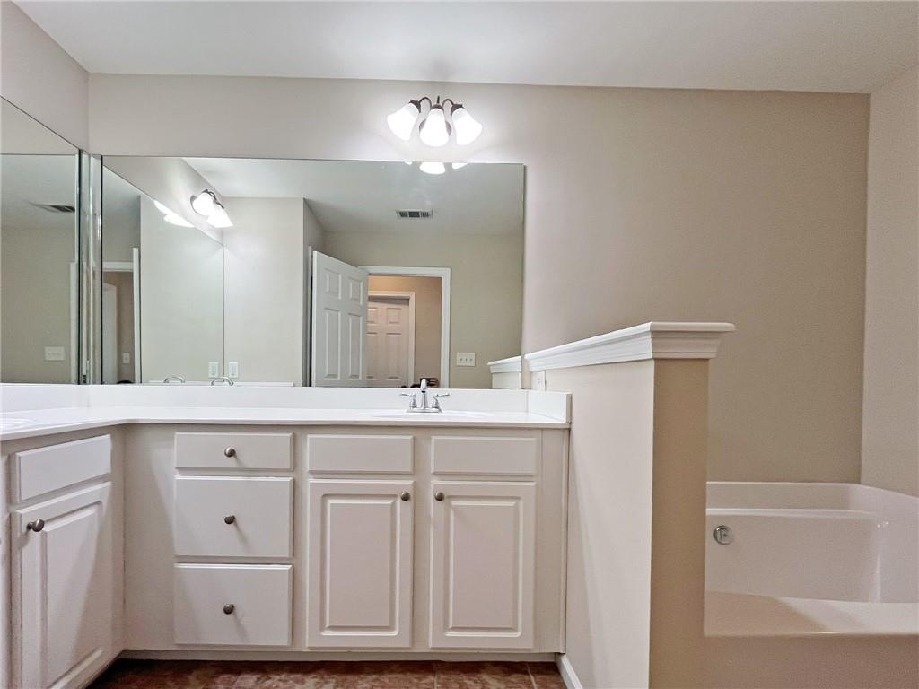 525 Grove Field Court Northwest Suwanee, GA 30024 - Photo 36 of 57 a bathroom with a sink double vanity and a mirror