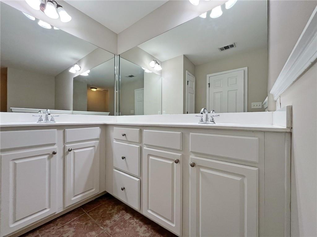 525 Grove Field Court Northwest Suwanee, GA 30024 - Photo 37 of 57 a bathroom with a sink and a mirror