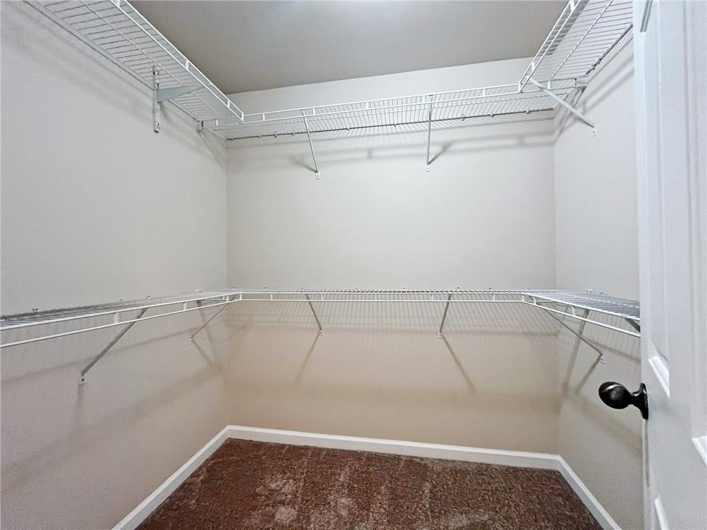 525 Grove Field Court Northwest Suwanee, GA 30024 - Photo 40 of 57 a view of a room with racks on the wall