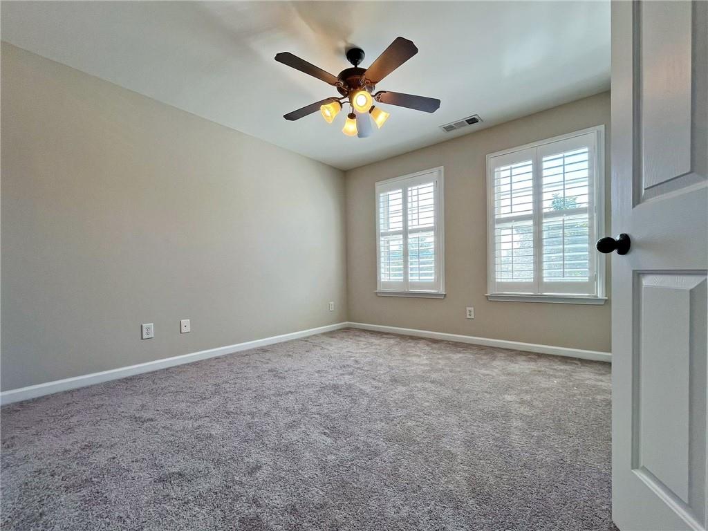 525 Grove Field Court Northwest Suwanee, GA 30024 - Photo 42 of 57 a view of an empty room with a window