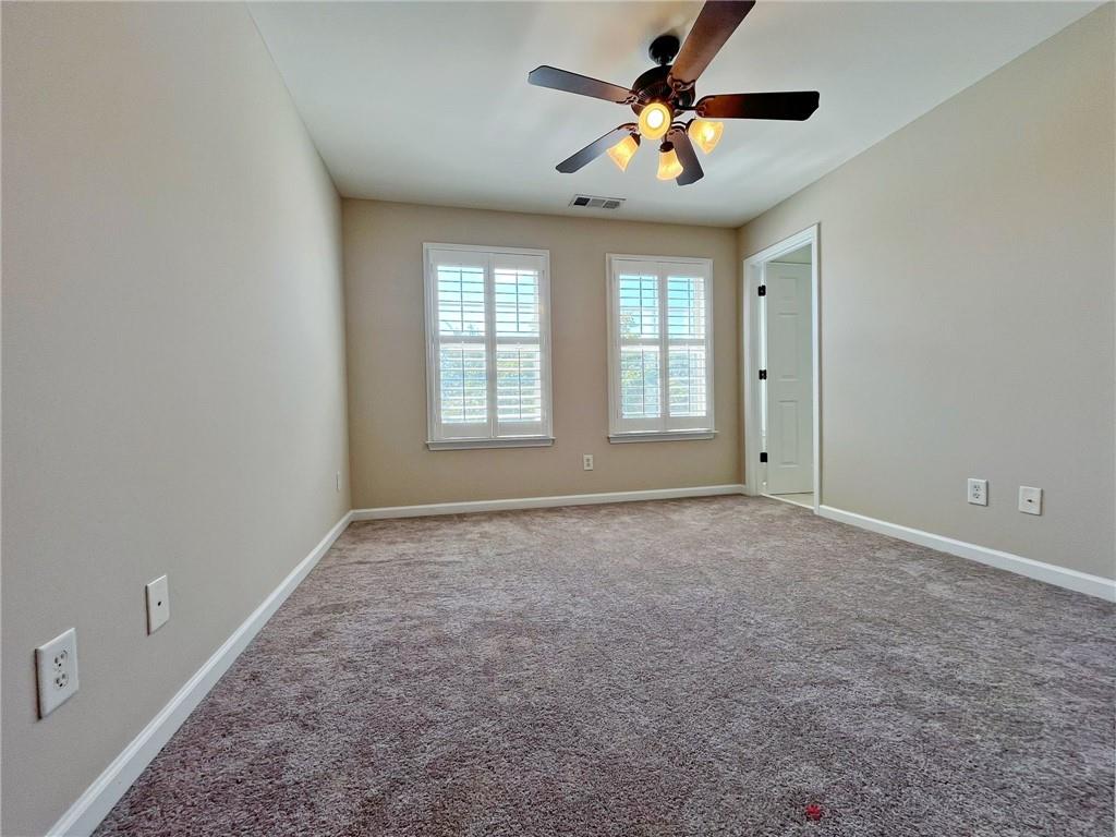 525 Grove Field Court Northwest Suwanee, GA 30024 - Photo 43 of 57 a view of an empty room with a window