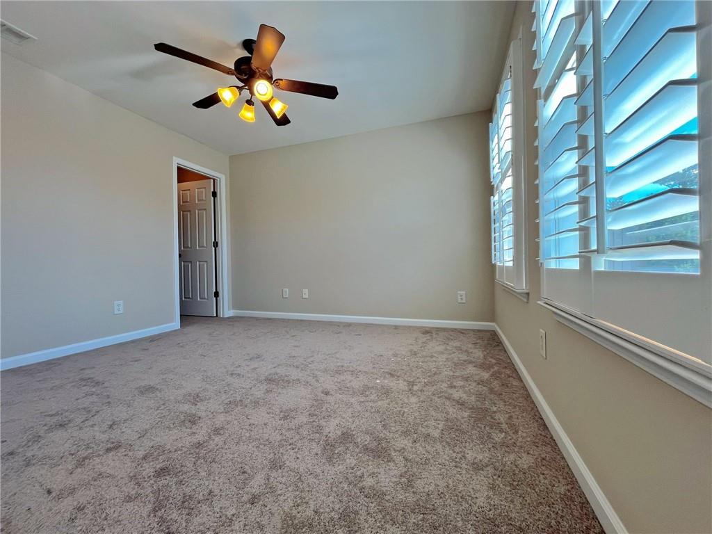 525 Grove Field Court Northwest Suwanee, GA 30024 - Photo 44 of 57 a view of an empty room with a window