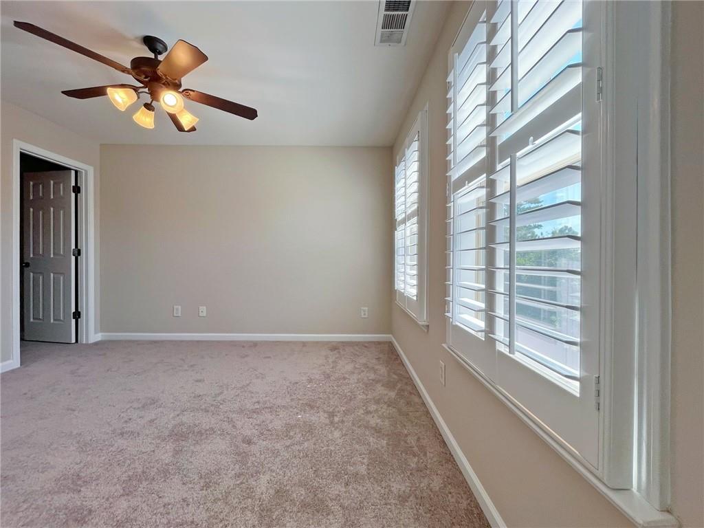 525 Grove Field Court Northwest Suwanee, GA 30024 - Photo 45 of 57 a view of an empty room with a window