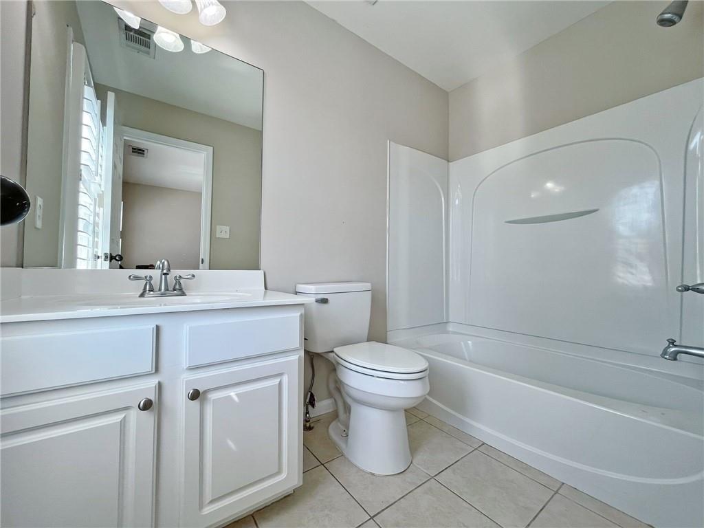 525 Grove Field Court Northwest Suwanee, GA 30024 - Photo 48 of 57 a bathroom with a sink toilet a vanity and bathtub
