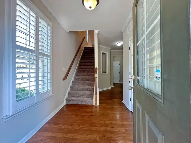 a view of an entryway with wooden floor and windows
