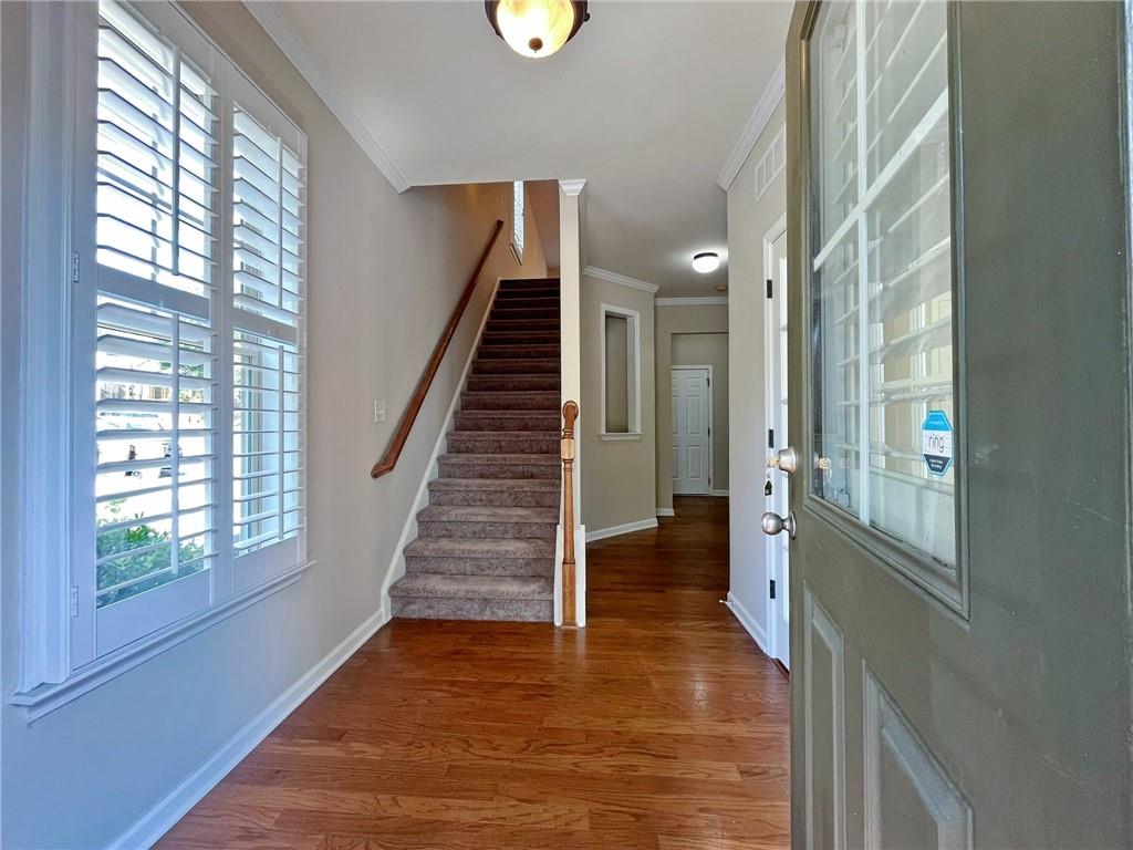 525 Grove Field Court Northwest Suwanee, GA 30024 - Photo 5 of 57 a view of an entryway with wooden floor and windows