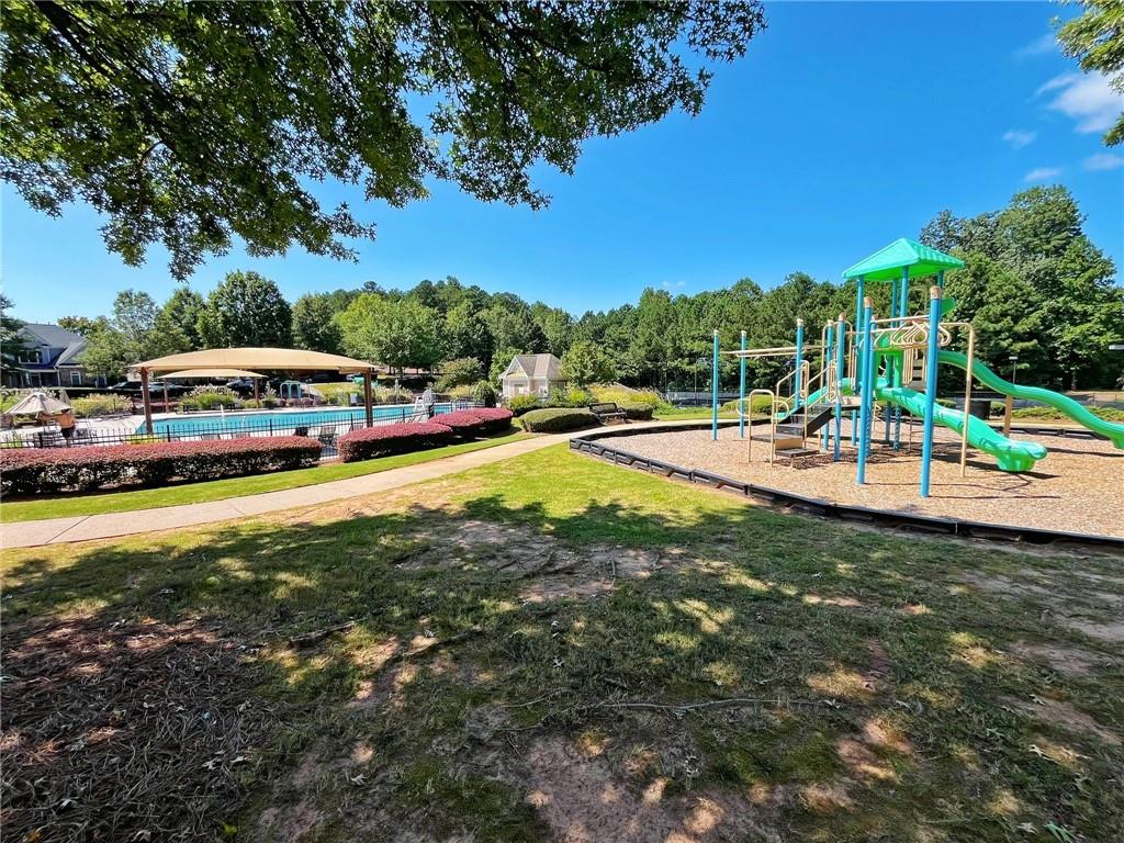 525 Grove Field Court Northwest Suwanee, GA 30024 - Photo 51 of 57 an outdoor space with swimming pool and furniture