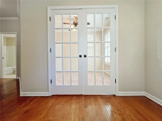 wooden floor in an empty room with a window
