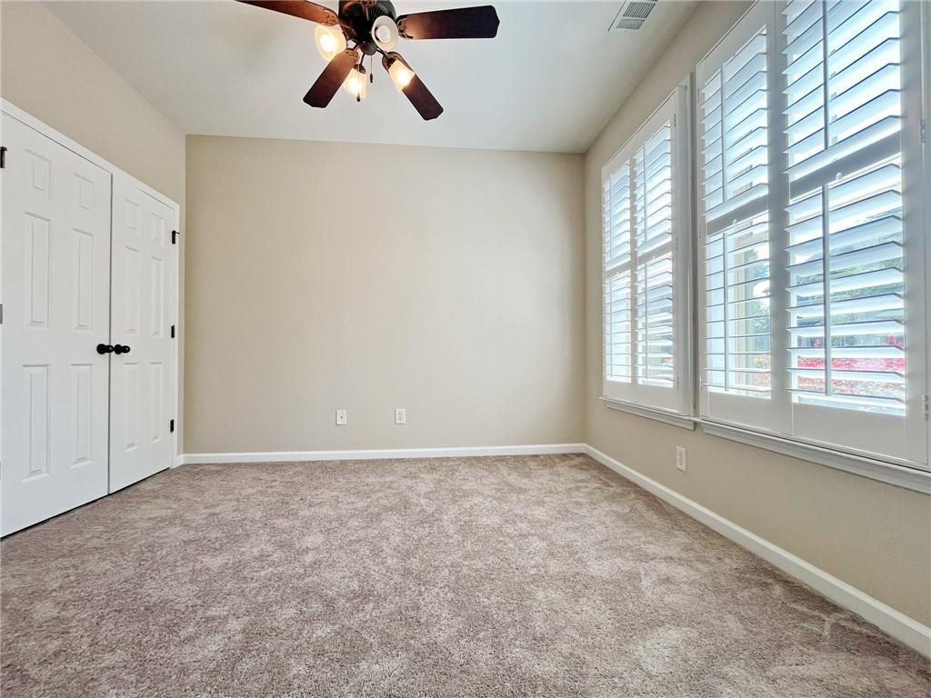 525 Grove Field Court Northwest Suwanee, GA 30024 - Photo 8 of 57 wooden floor in an empty room with a window