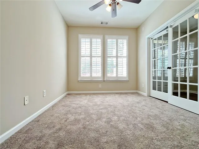 an empty room with wooden floor and a bathroom