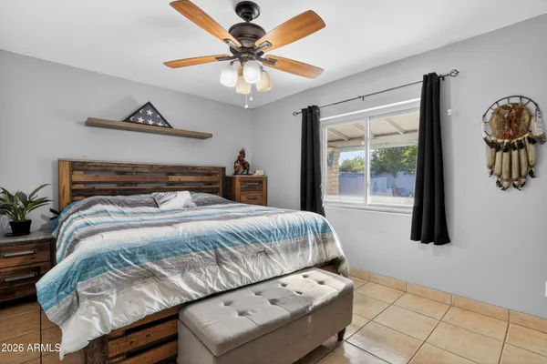 a bedroom with a bed and a ceiling fan