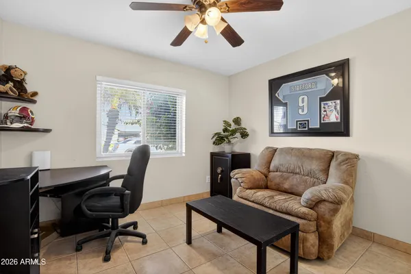 a bathroom with a granite countertop toilet sink and mirror