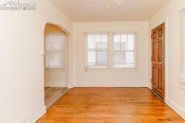 a view of a hallway with wooden floor and entryway
