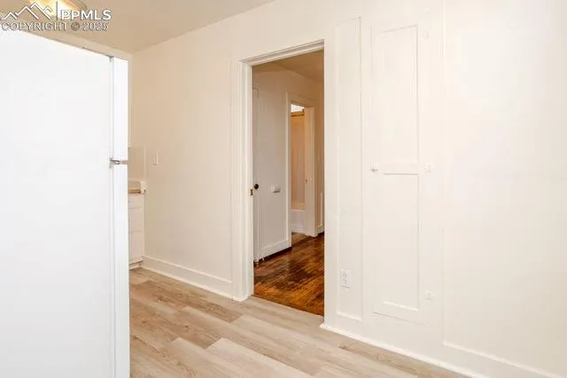 a view of empty room with wooden floor