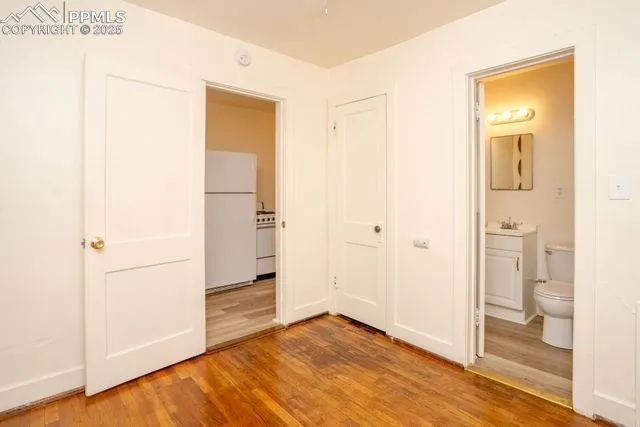 a white toilet sitting next to a white sink and a shower