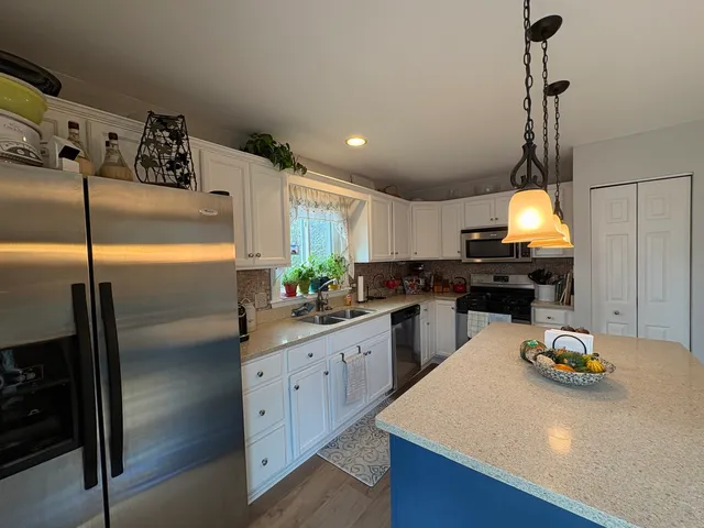 a kitchen with sink a stove and cabinets