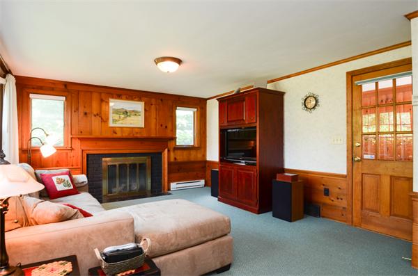 107 Viscount Road Longmeadow, MA 01106 - Photo 14 of 30 a living room with furniture a flat screen tv and a fireplace