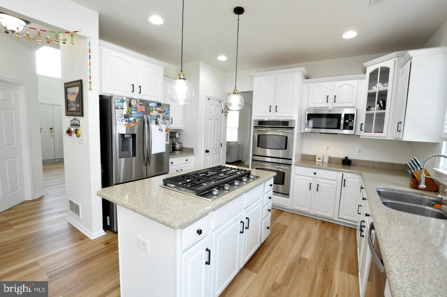 8 Jasmine Way Sewell, NJ 08080 - Photo 13 of 38 a kitchen with white cabinets and stainless steel appliances