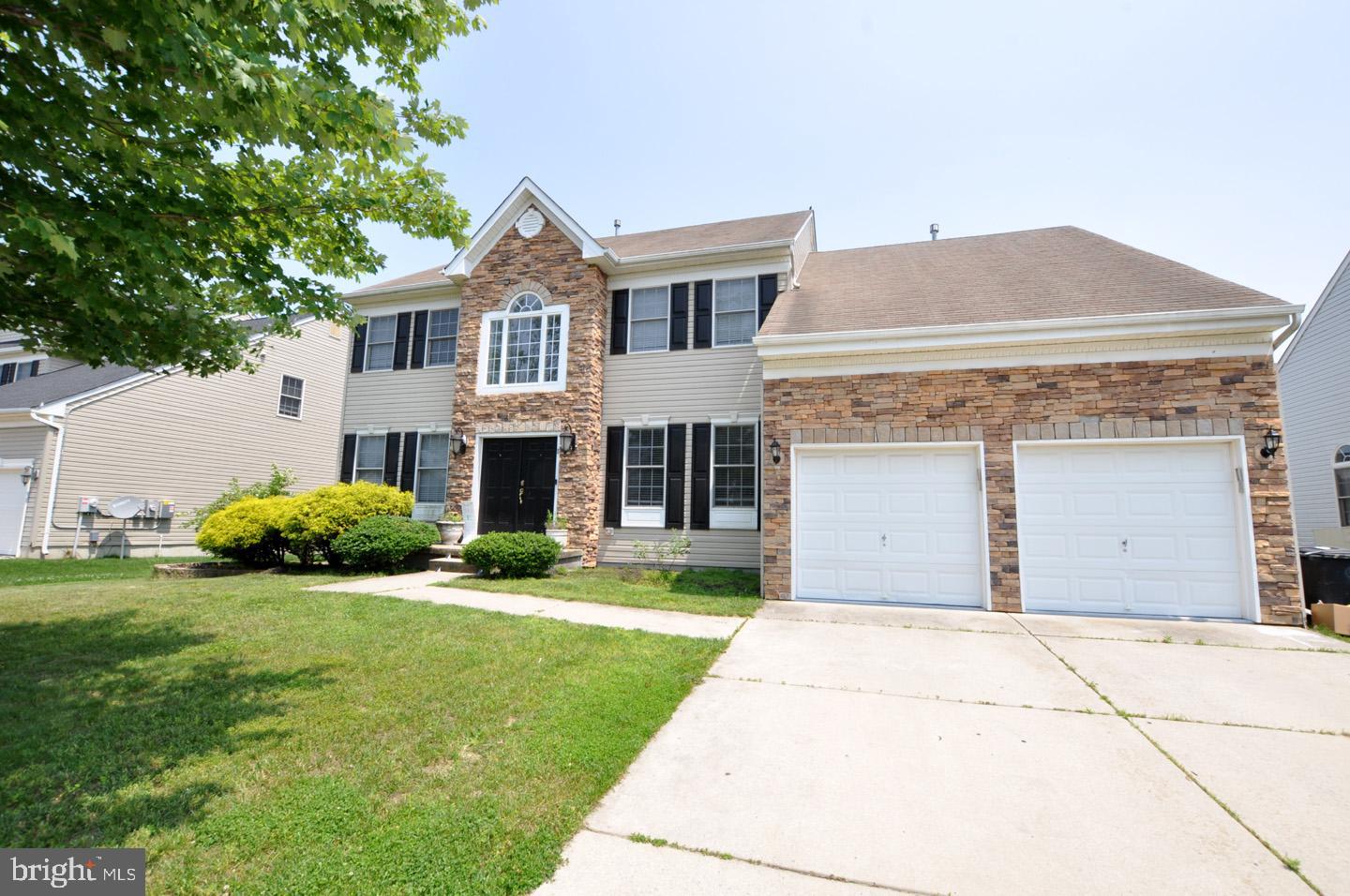 8 Jasmine Way Sewell, NJ 08080 - Photo 3 of 38 a front view of a house with a garden and yard