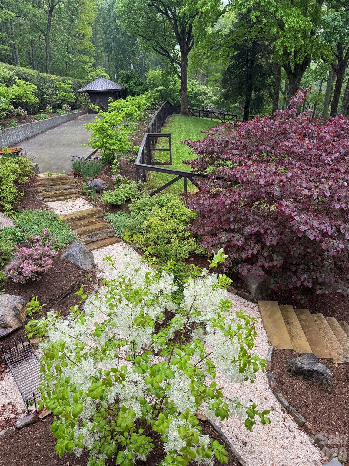 191 North Fork Road Burnsville, NC 28714 - Photo 43 of 48 a view of a garden with a bench