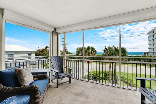 a bedroom with a large bed a couch and two windows