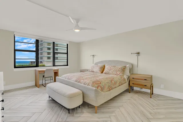 a bedroom with a bed and ceiling fan