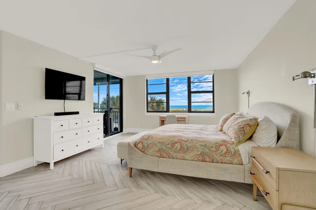 a view of a bedroom with furniture and window
