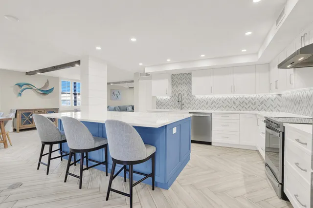 a kitchen with a table chairs sink and cabinets