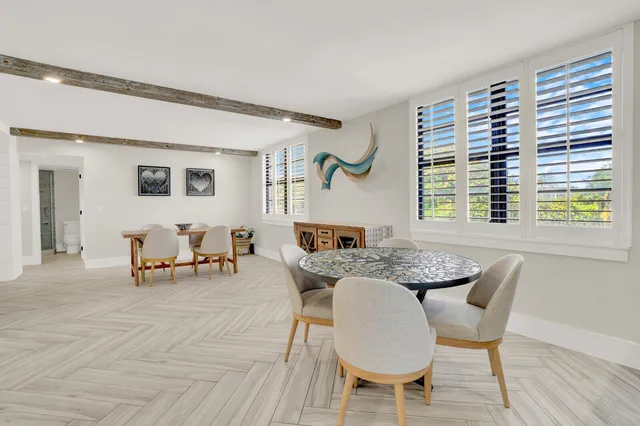 a view of a dining room with furniture and a window